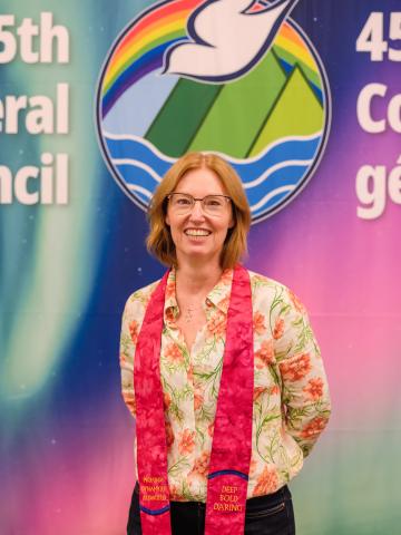 Rev. Dr. Kimberly Heath in front of the GC45 logo